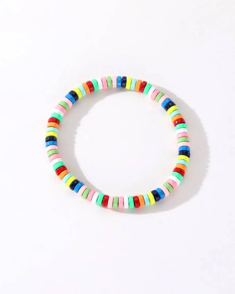 Colorful enamel stacking bracelet by Greenwood Designs featuring vibrant, multi-colored metal bangles stacked together.