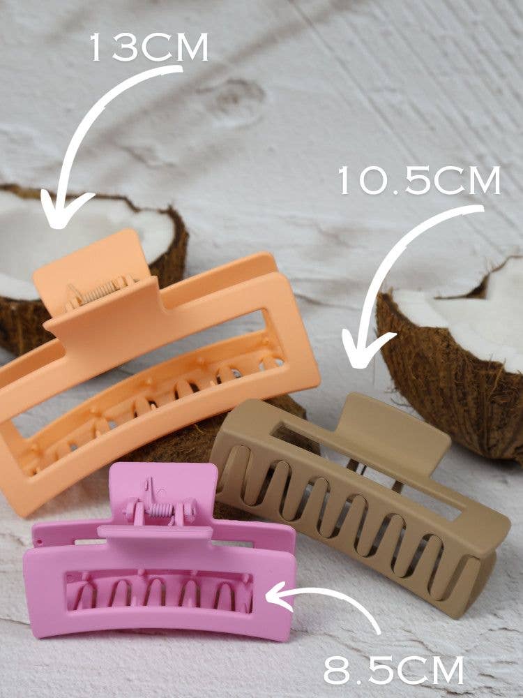 Medium elongated rectangle claw clip by Nakoa The Label in strawberry shortcake color, showcasing its smooth, glossy surface.