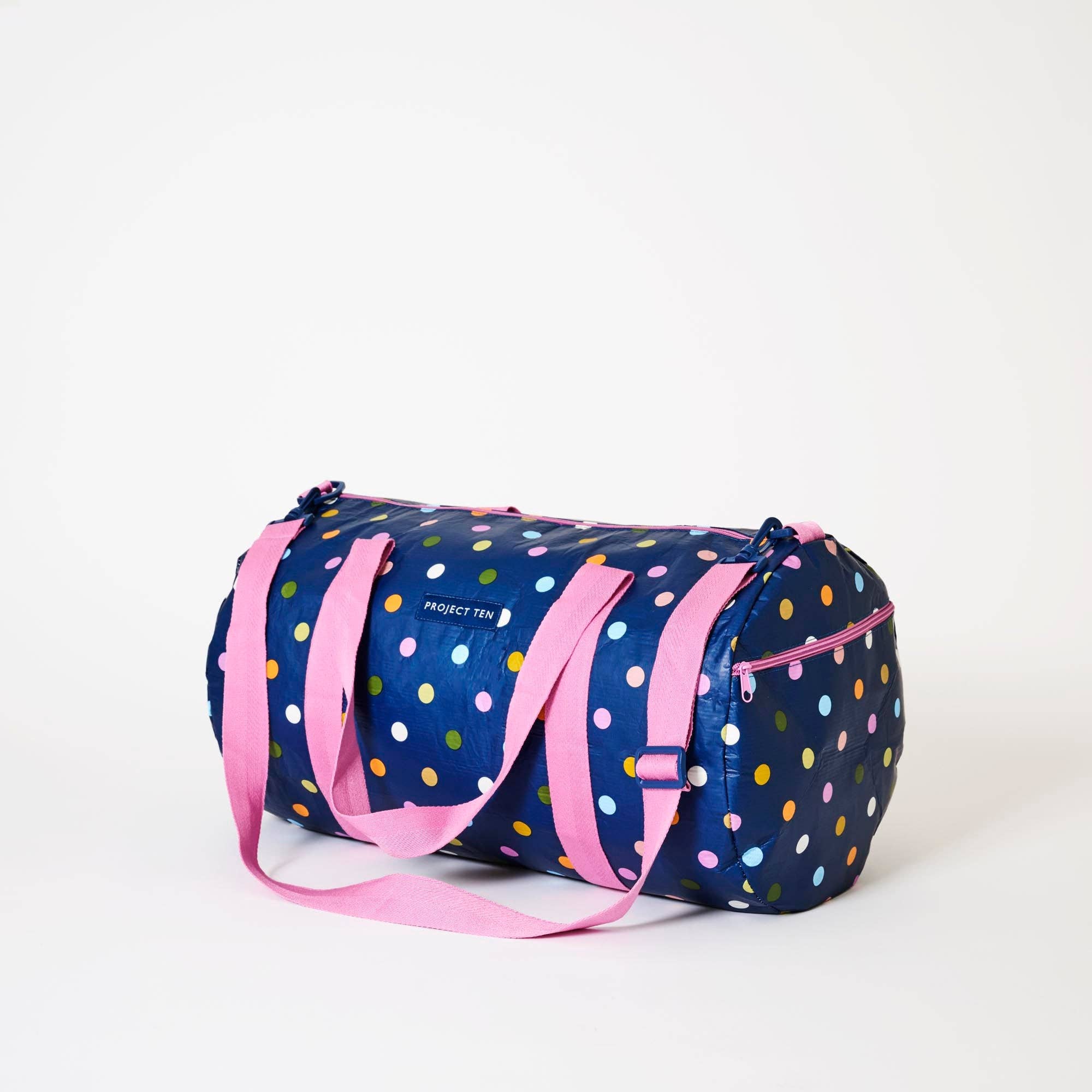 Confetti-patterned barrel bag from Project Ten Pty Ltd with a cylindrical shape and sturdy leather straps.