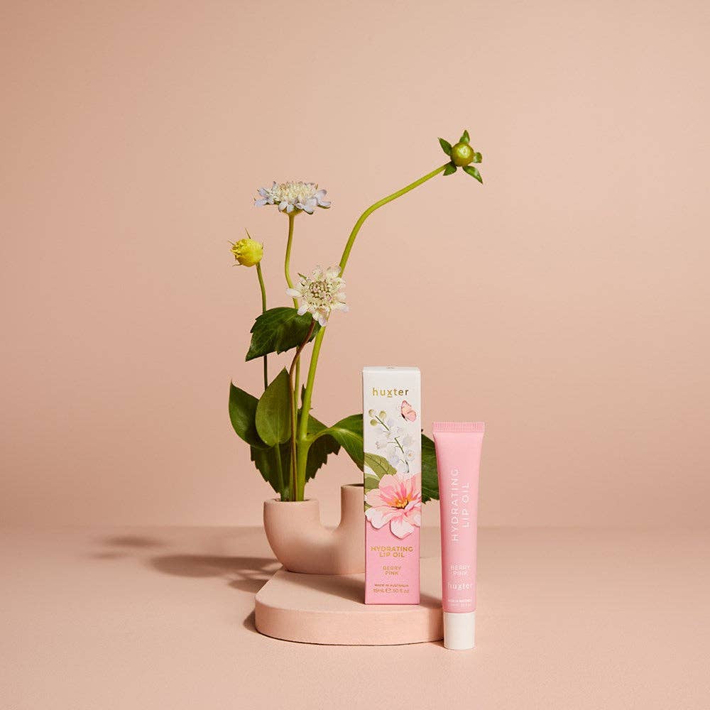 Huxter 15ml hydrating lip oil in berry pink, limited edition boxed, featuring sleek packaging and applicator on a white background.