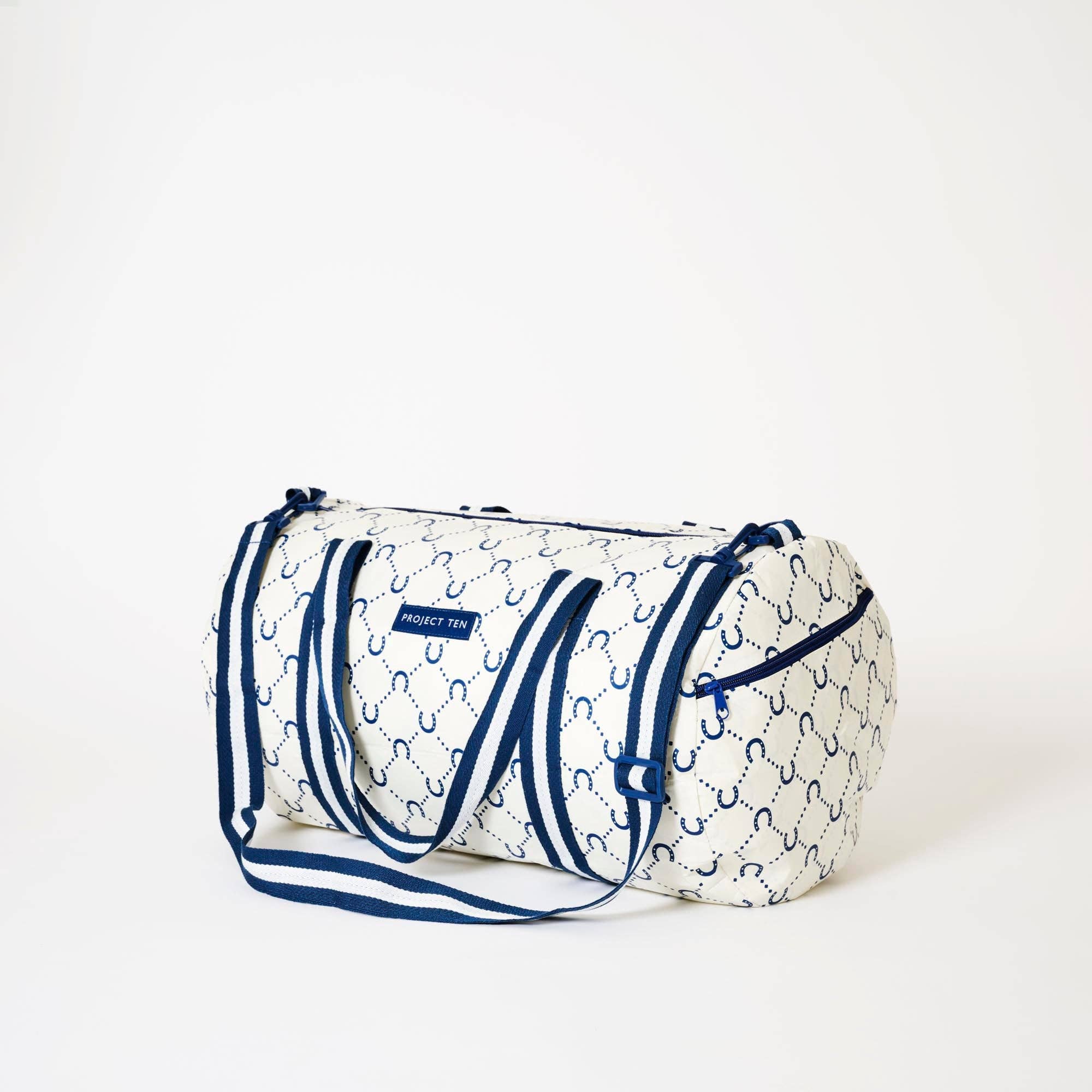Navy barrel bag with horseshoe design from Project Ten Pty Ltd, showing the textured leather and sturdy handles.