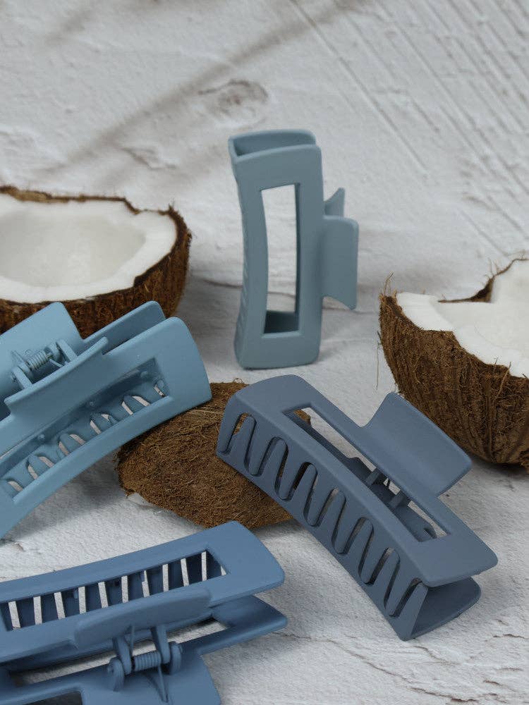Medium blue elongated rectangle claw clip by Nakoa The Label, showing a glossy plastic hair accessory with smooth edges