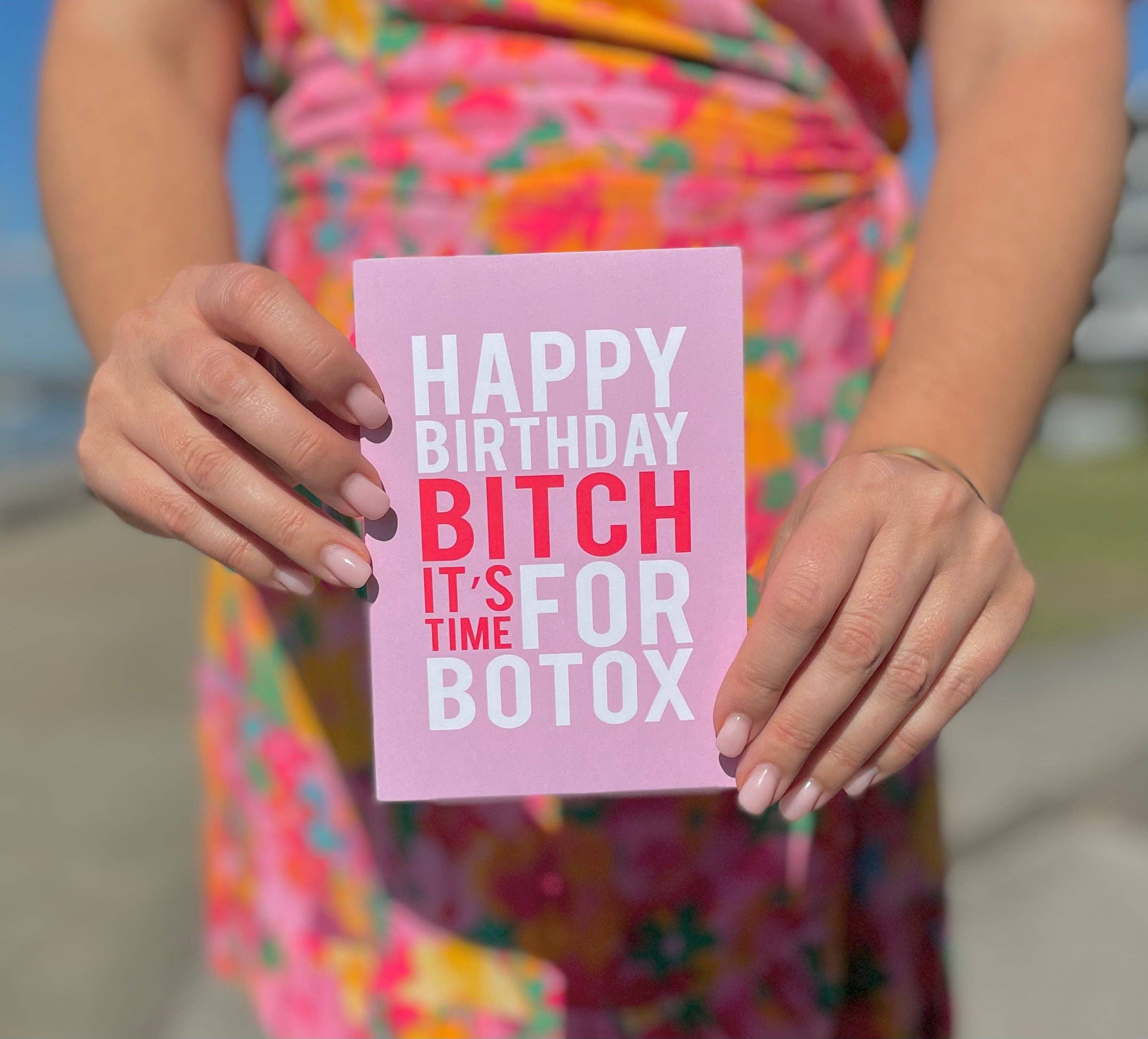 Pink and red birthday greeting card featuring "Botox" message by BAD ON PAPER, with festive design and decorative elements.