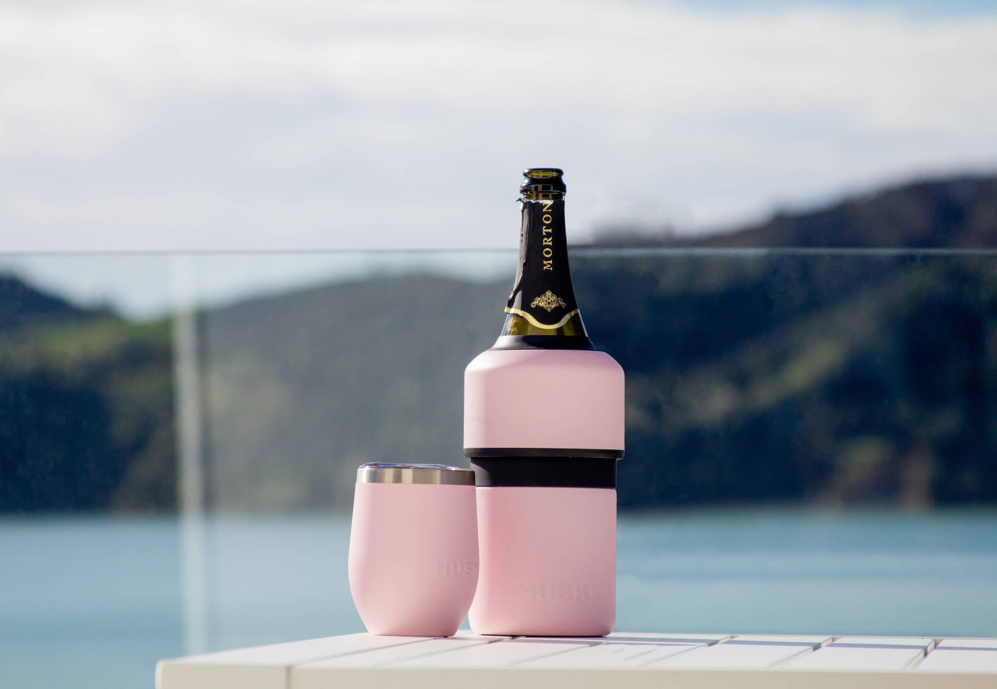 Huski Powder Pink wine cooler with insulated stainless steel exterior, designed to keep wine chilled.