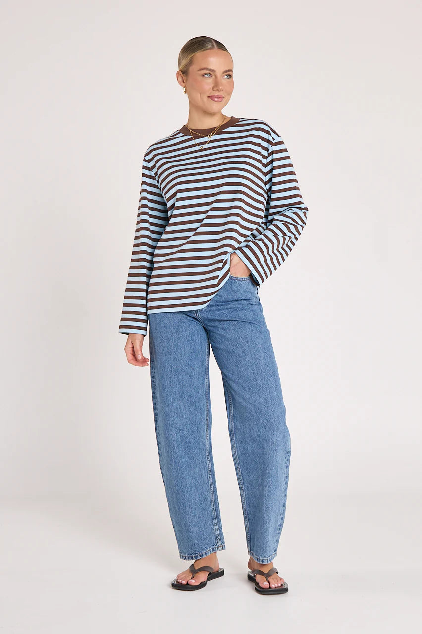 Feather + Noise Carter long sleeve tee in chocolate blue stripe, featuring soft fabric and casual fit, displayed on a hanger.