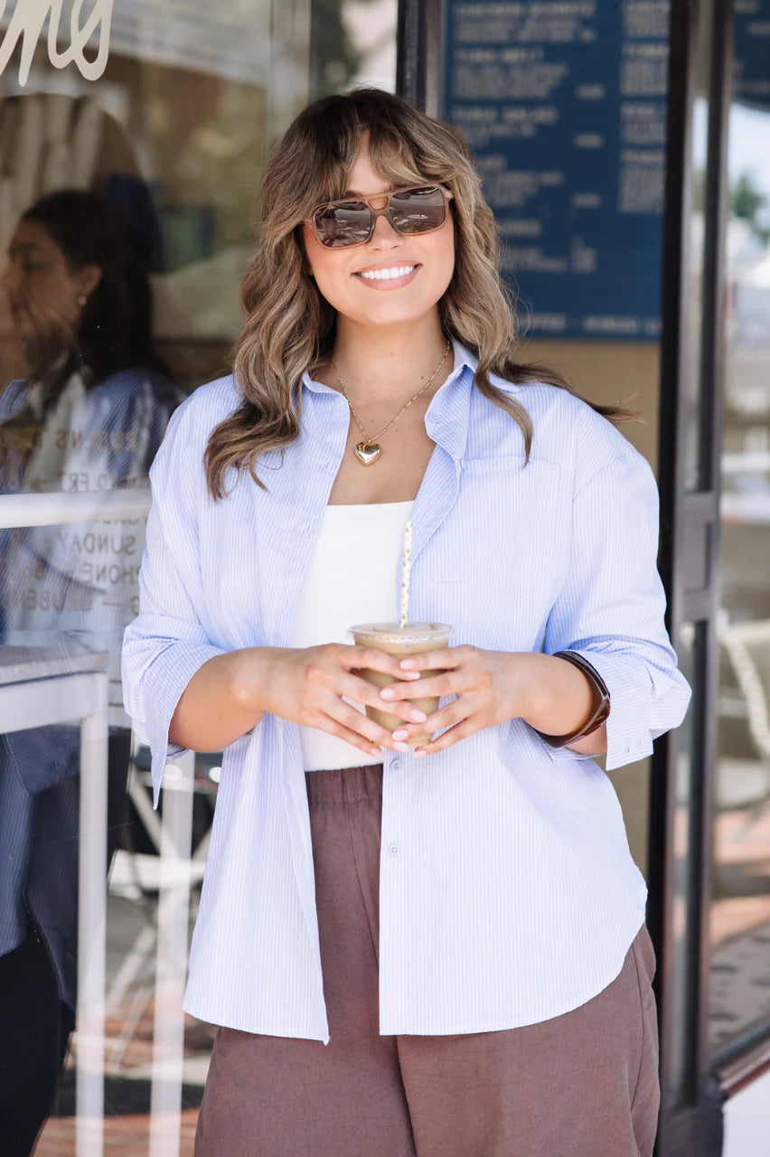Blue striped Emily shirt by Feather + Noise, featuring a stylish casual design with button details and a relaxed fit.