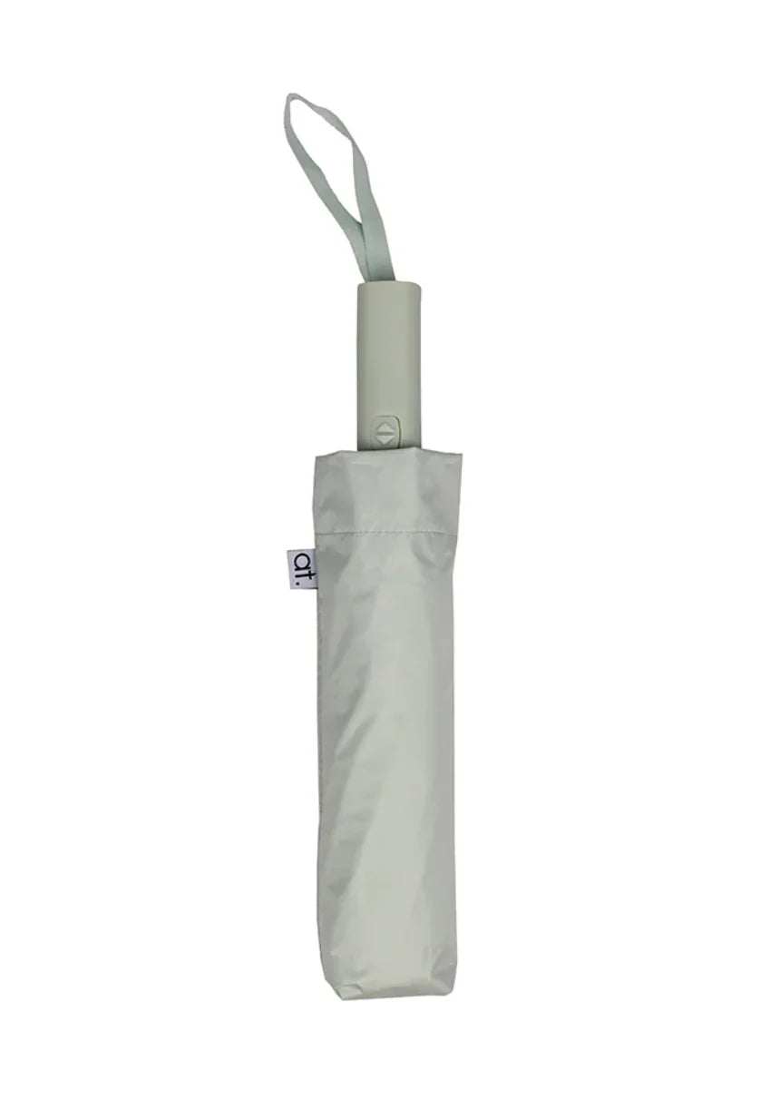 Annabel Trends compact auto open and close umbrella, showing its black canopy and sleek handle in a close-up shot.