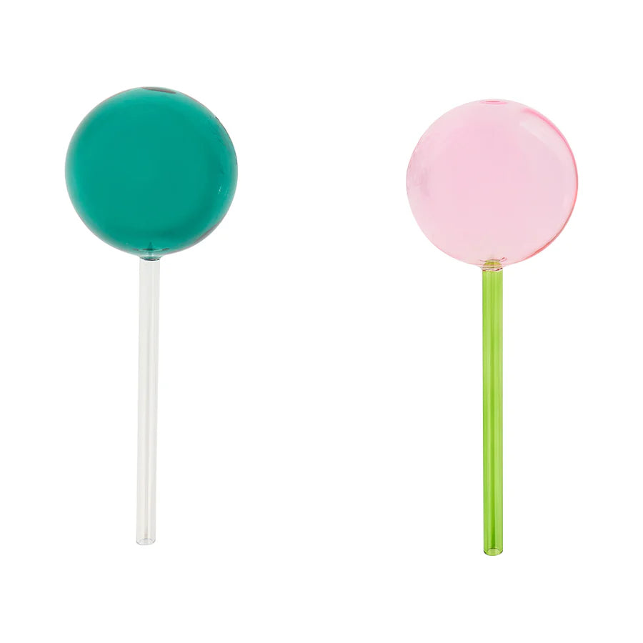 Set of two pink and green plant water globes by Annabel Trends for automatic watering of indoor and outdoor plants.
