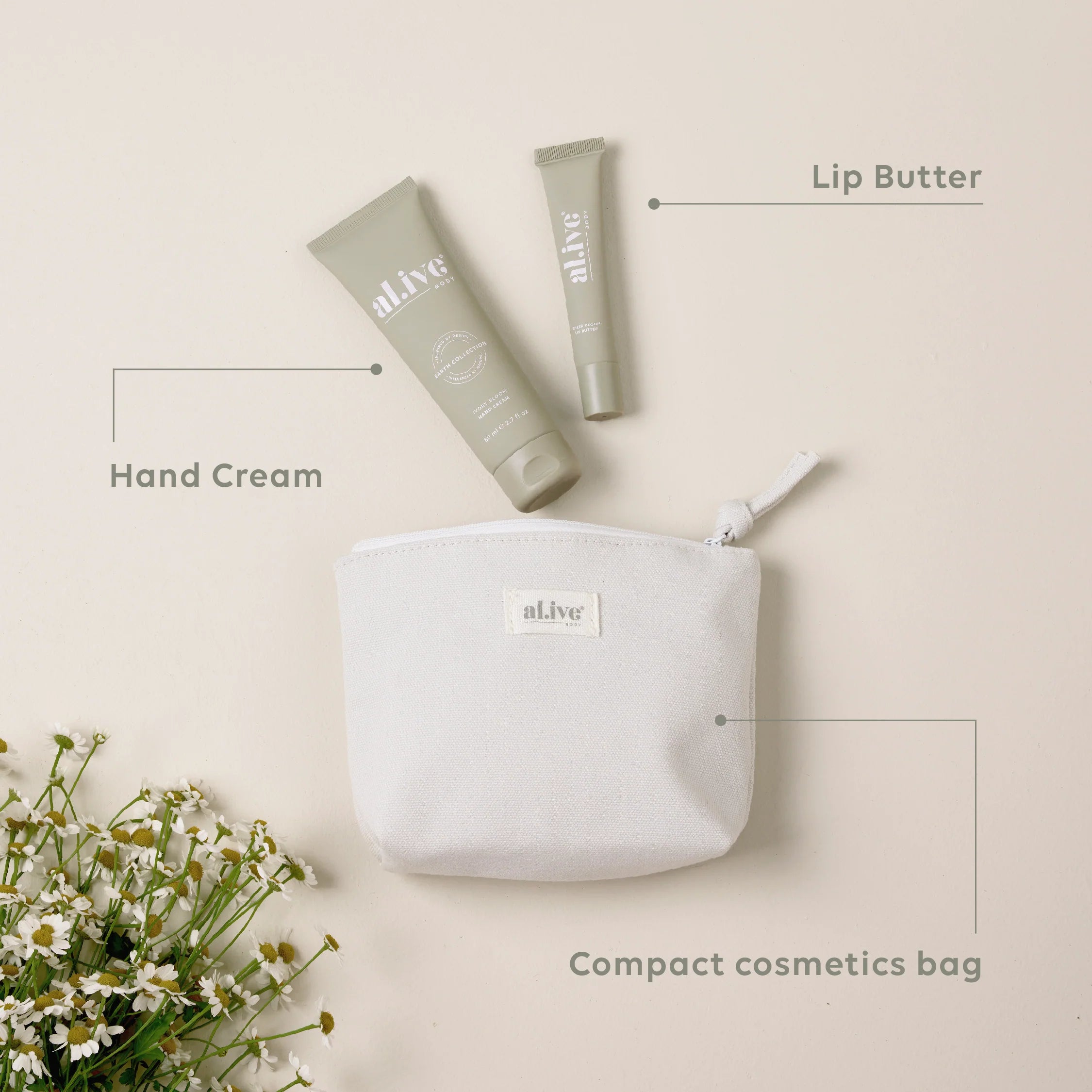 Ivory Bloom hand and lip set from Al.ive Body featuring ivory-colored packaging and skincare products in a natural setting.