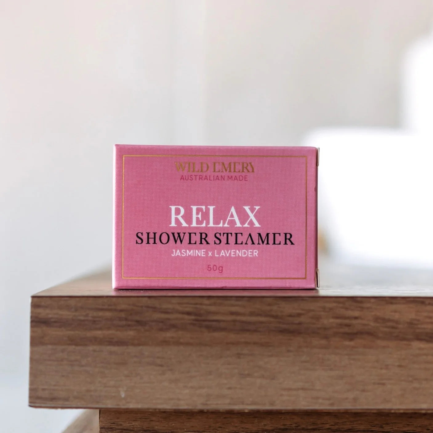 Wild Emery Relax shower steamer emitting steam and scent in a bathroom setting, designed for a calming shower experience.