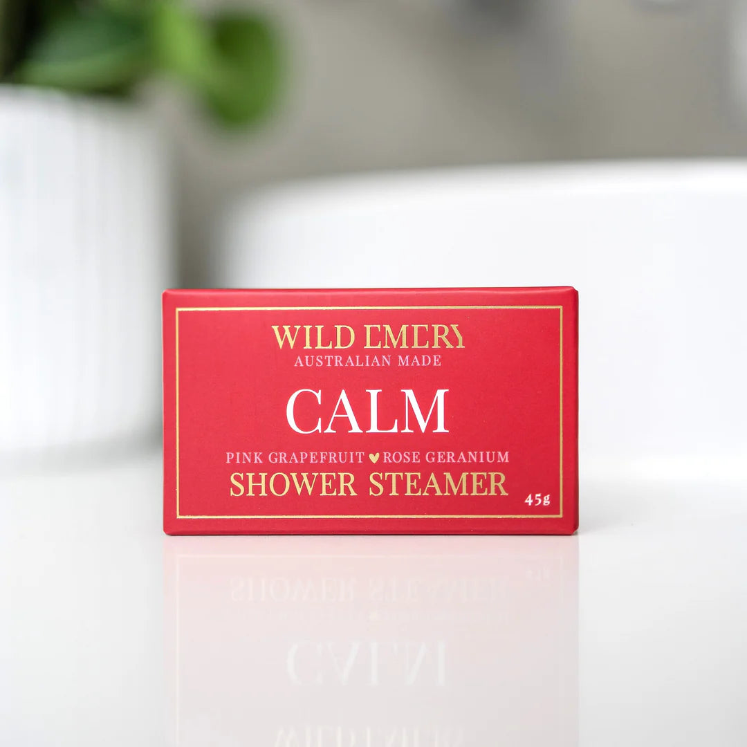 Wild Emery Calm Shower Steamer emitting steam and calming scents, designed for a relaxing shower experience.