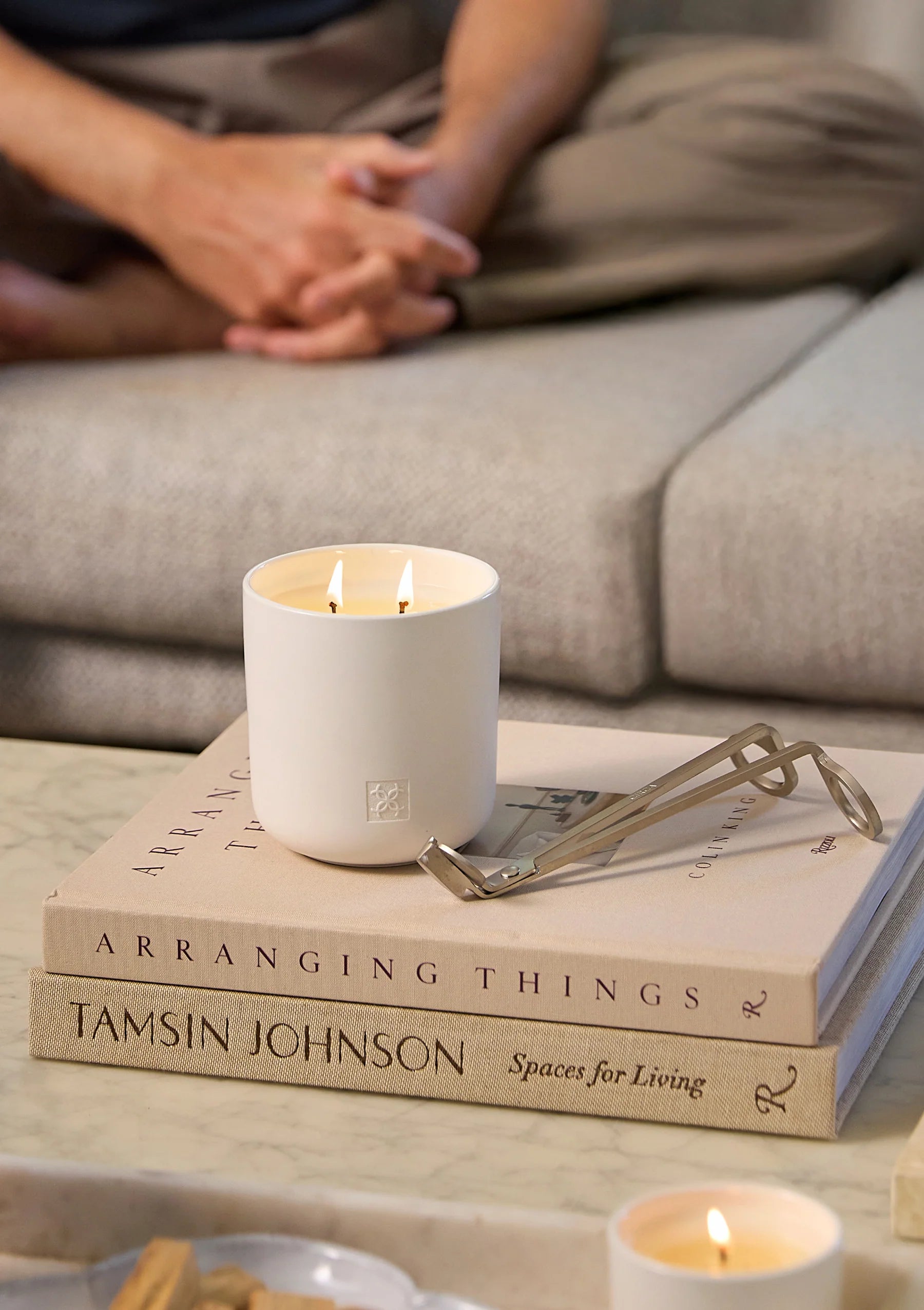 Ceramic jar of CIrca Jasmine & Magnolia soy candle, 300g, with a lit wick and floral scent, in a decorative container.