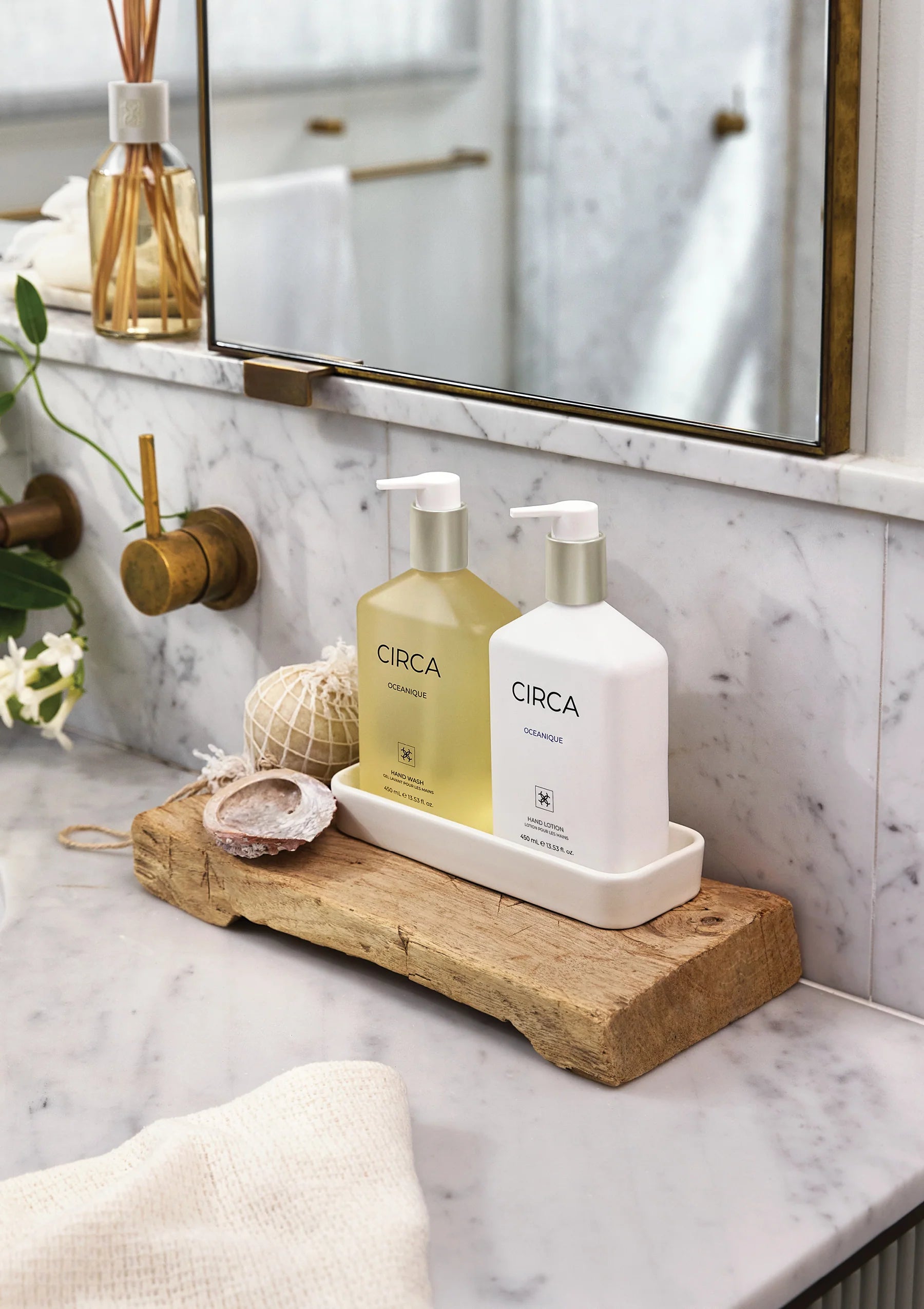 Circa OCEANIQUE hand lotion 450ml bottle with pump dispenser, featuring a sleek blue label and white cap, on a white background.