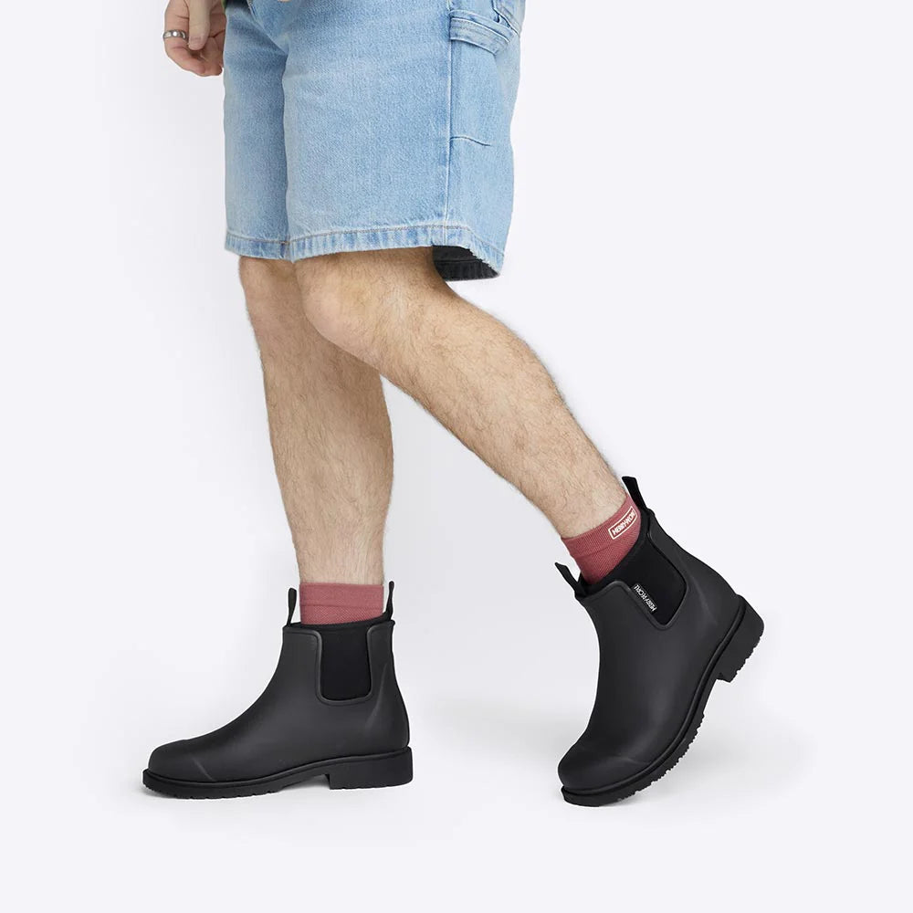 Black Bobbi ankle boot by Merry People with sleek design and pointed toe, shown from side view in the image.
