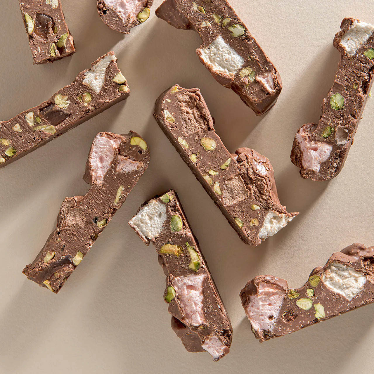 Milk chocolate Rocky Road in a 200g New Farm package with marshmallows, nuts, and biscuit pieces visible in the image.