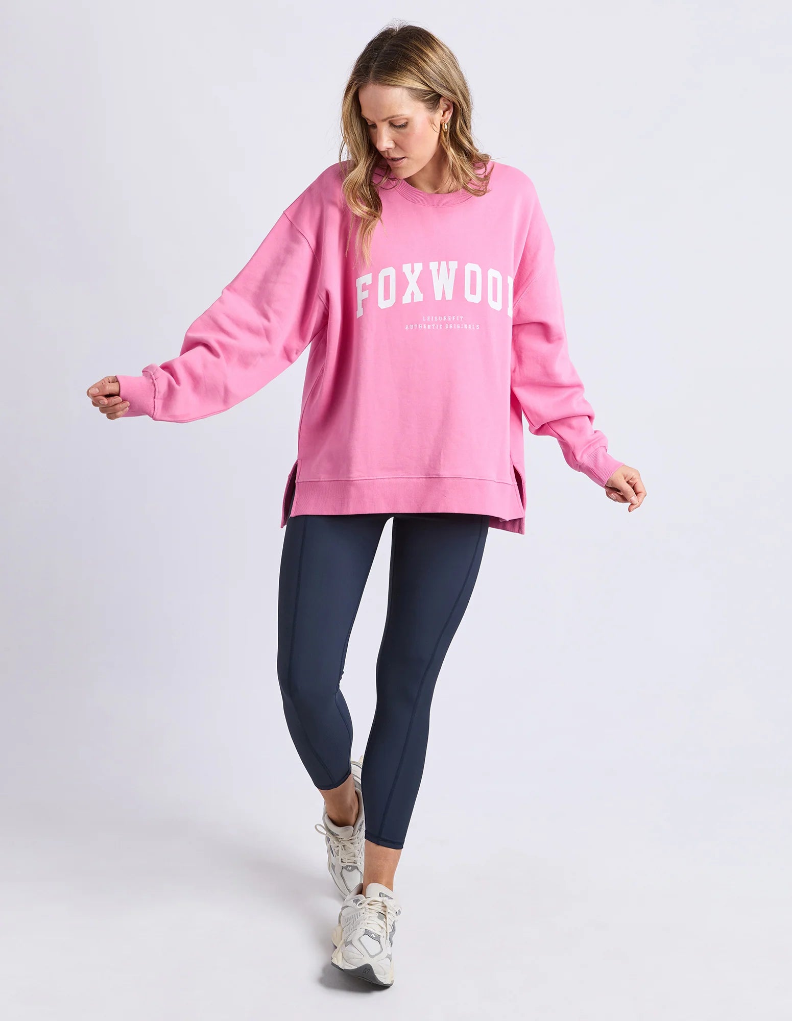 Foxwood Interval Crew Bubblegum Pink sweatshirt displayed on a hanger, showcasing its vibrant pink color and casual fit.