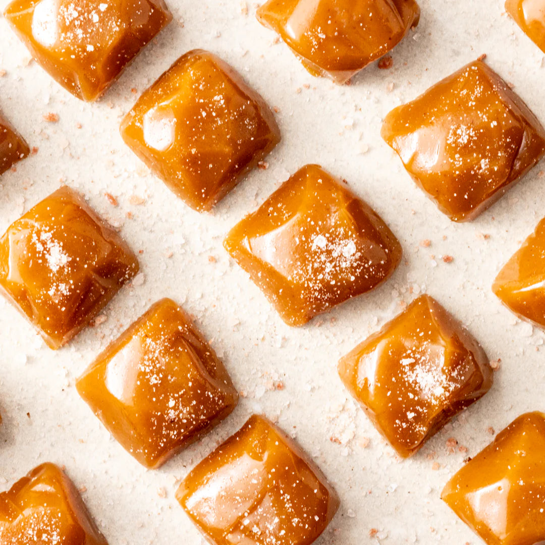 Salted caramel in a 100g package from New Farm, showing rich caramel pieces with a sprinkle of sea salt.