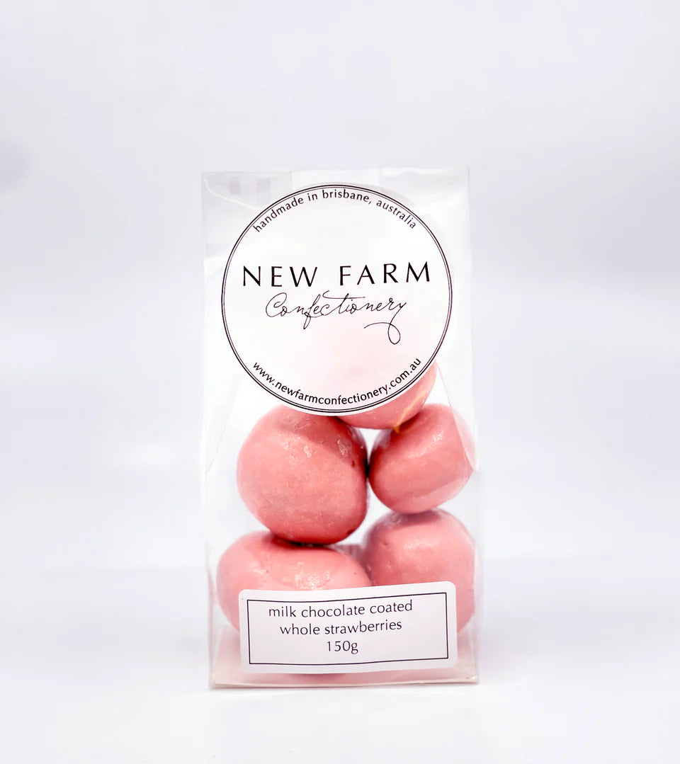 Milk chocolate coated whole strawberries in a 150g package from New Farm, showing glossy chocolate and fresh strawberries.