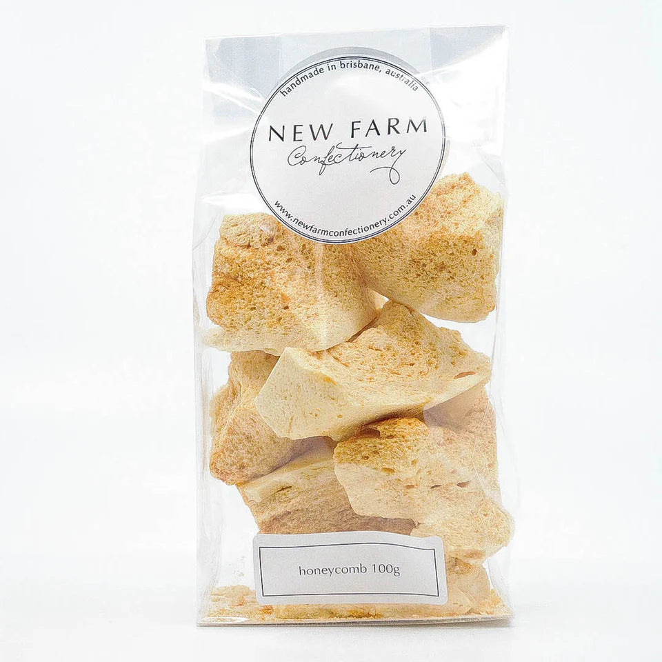 Fresh honeycomb 100g from New Farm, showing golden, textured beeswax with natural honey drips on the surface.