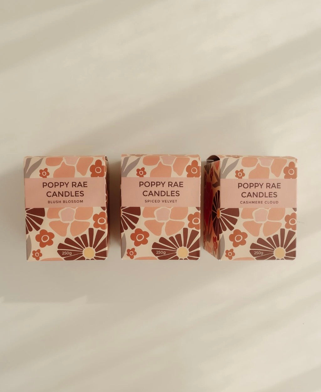 Poppy Rae Blush Blossom candle in a 250g glass jar with a floral design and soft pink wax, suitable for home decor.