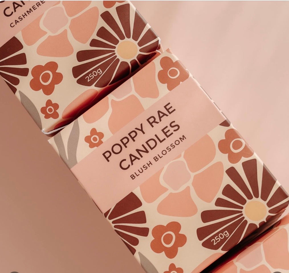 Poppy Rae Blush Blossom 250g candle with soft pink wax and floral design, perfect for creating a cozy ambiance.