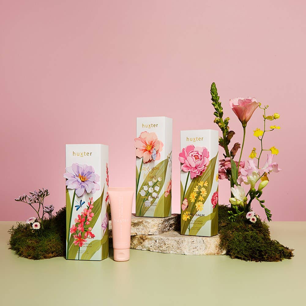 Huxter hand balm gift box with 50ml mauve flower, white floral, and French pear scent, featuring elegant packaging and white floral design.