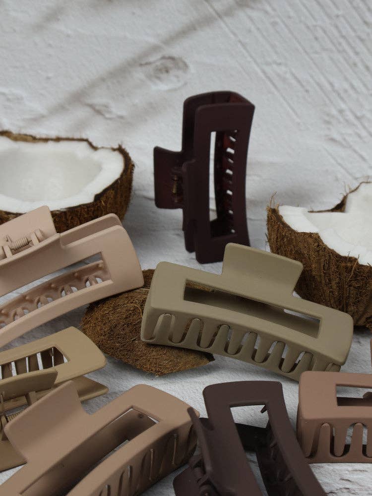 Medium elongated rectangle claw clip in cocoa color by Nakoa The Label, showcasing its smooth, curved design for secure hair holding.