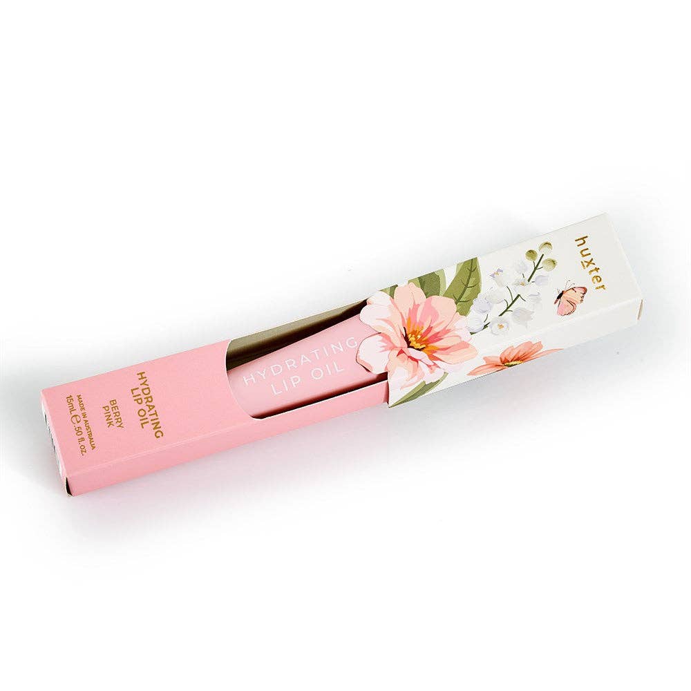 Huxter 15ml hydrating lip oil in limited edition Berry Pink box, featuring a clear tube with pink lip oil and applicator.