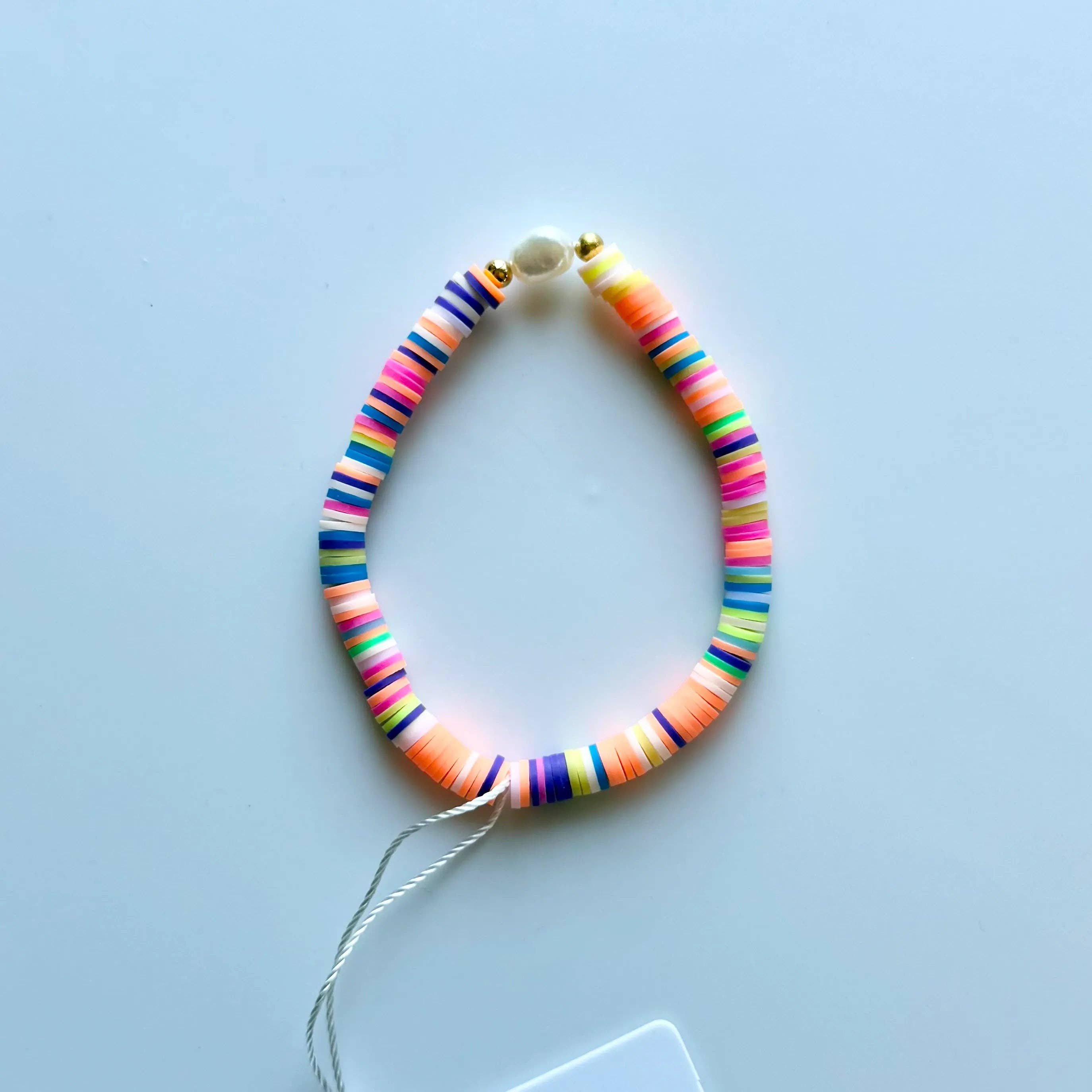 Pearl Pop Heishi Bead Bracelet by Greenwood Designs featuring white pearl and neutral-toned heishi beads on a stretch cord