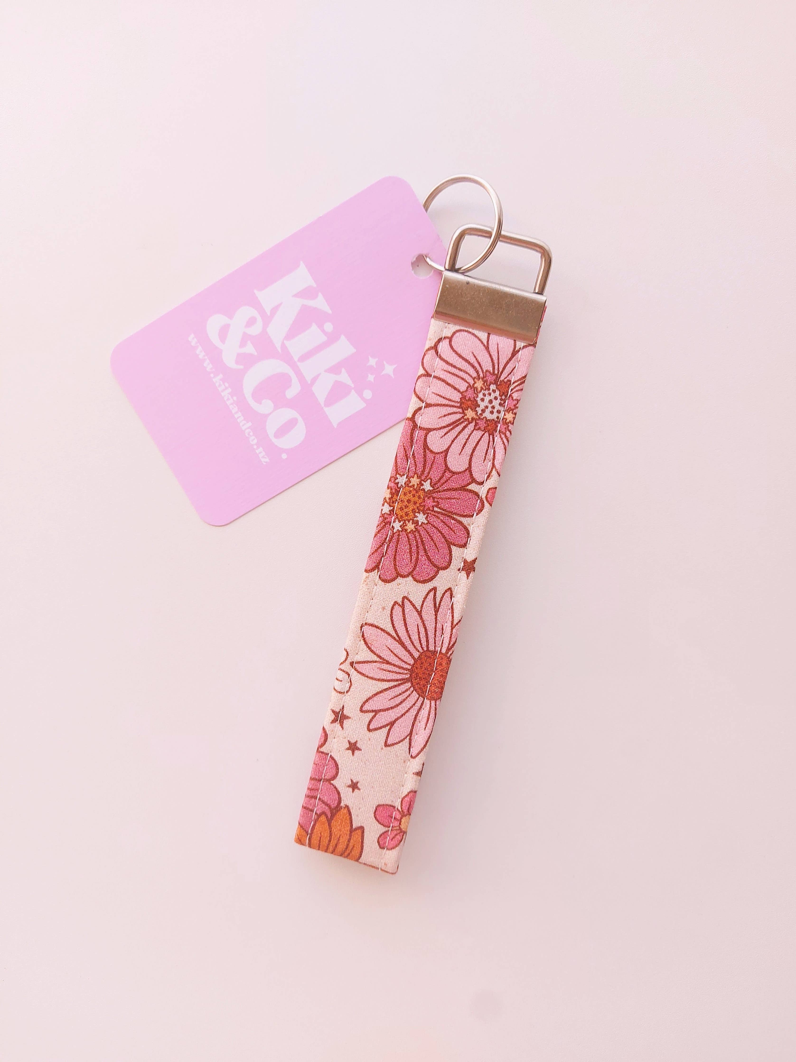 Kiki & Co. fall floral keychain with orange and yellow fabric flowers and gold keyring on a white background.
