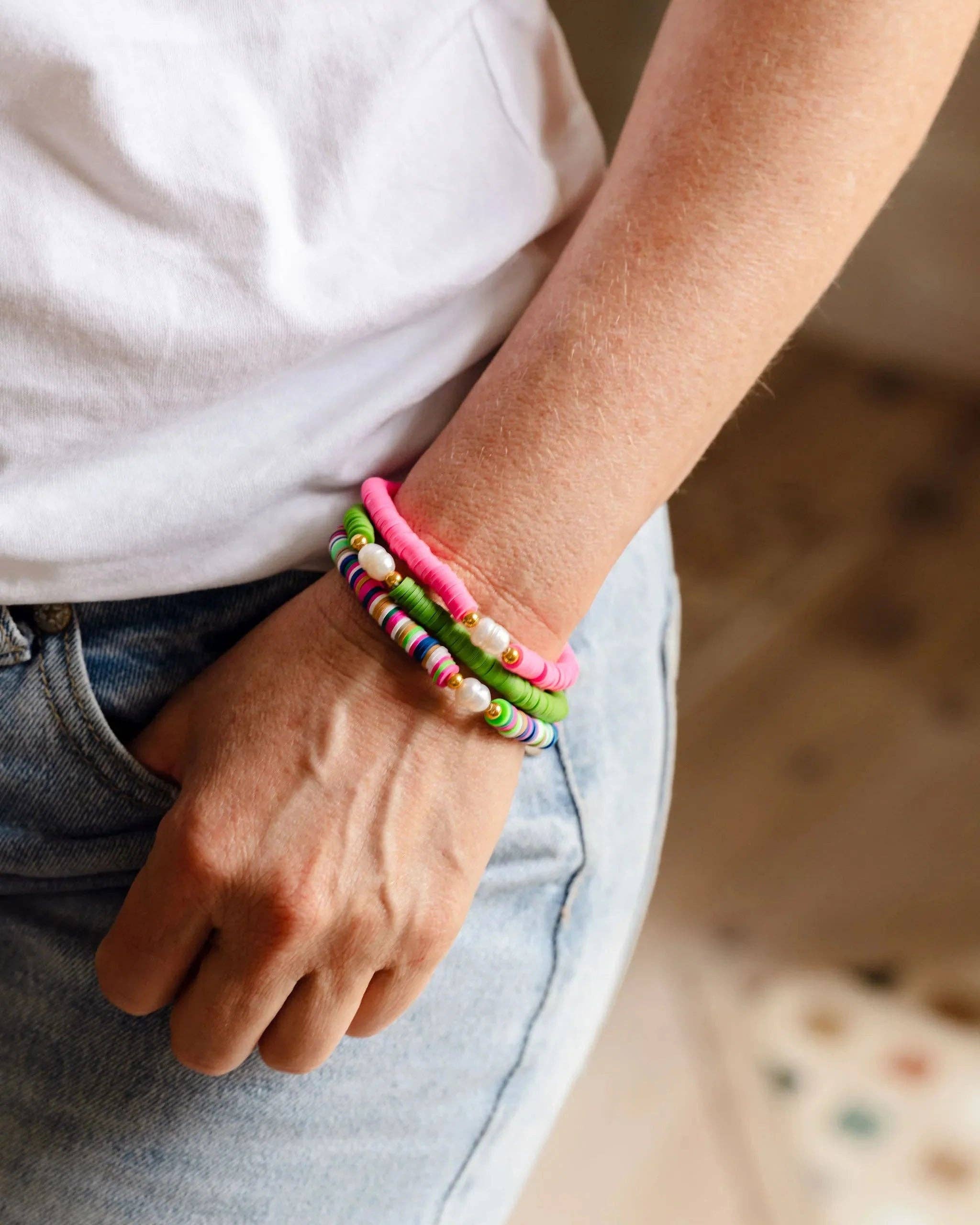 Pearl Pop Heishi Bead Bracelet by Greenwood Designs featuring white pearl and wooden heishi beads on an elastic band.