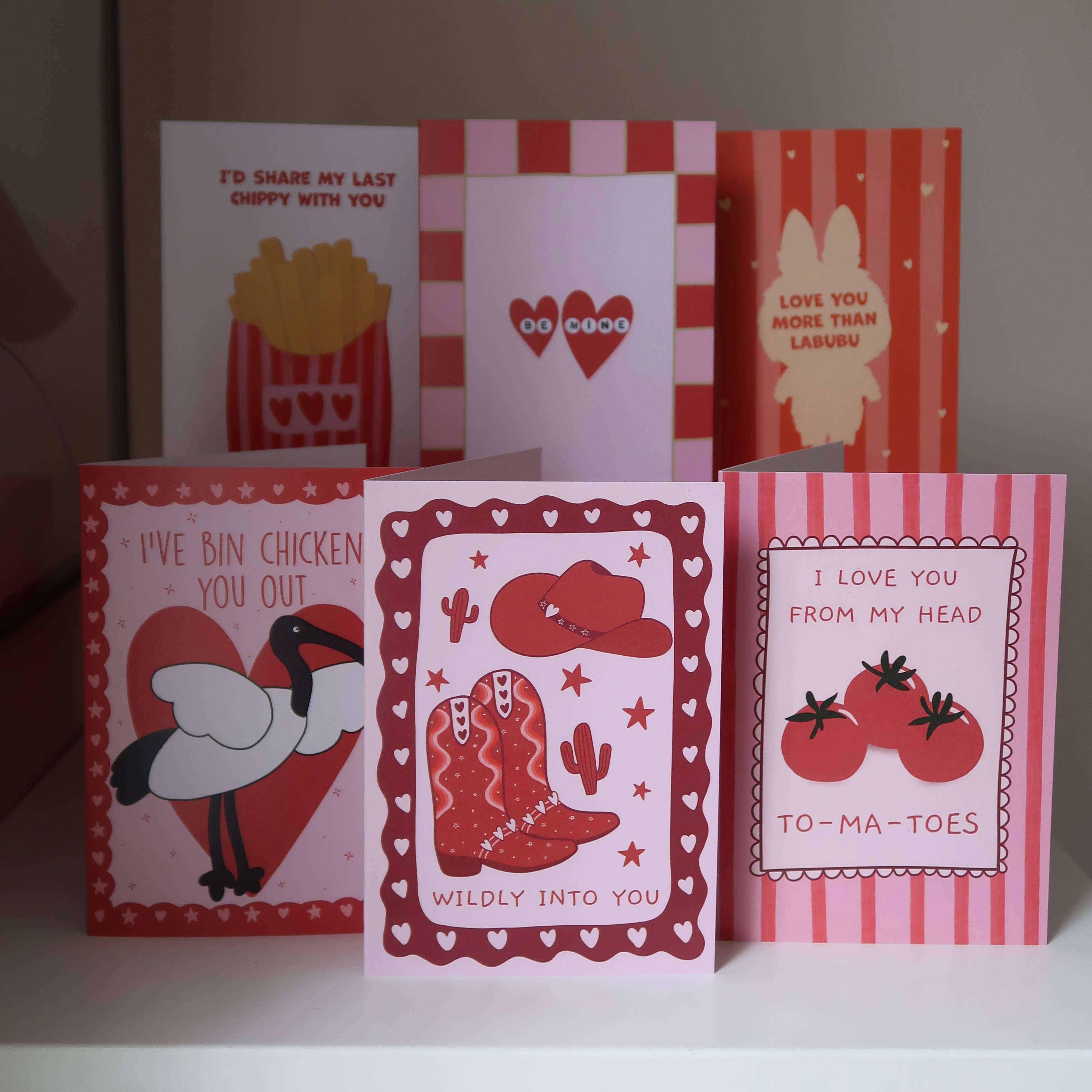 Valentine's Day card from Rosalie featuring a cowboy boot design with "Wildly Into You" love theme illustration.