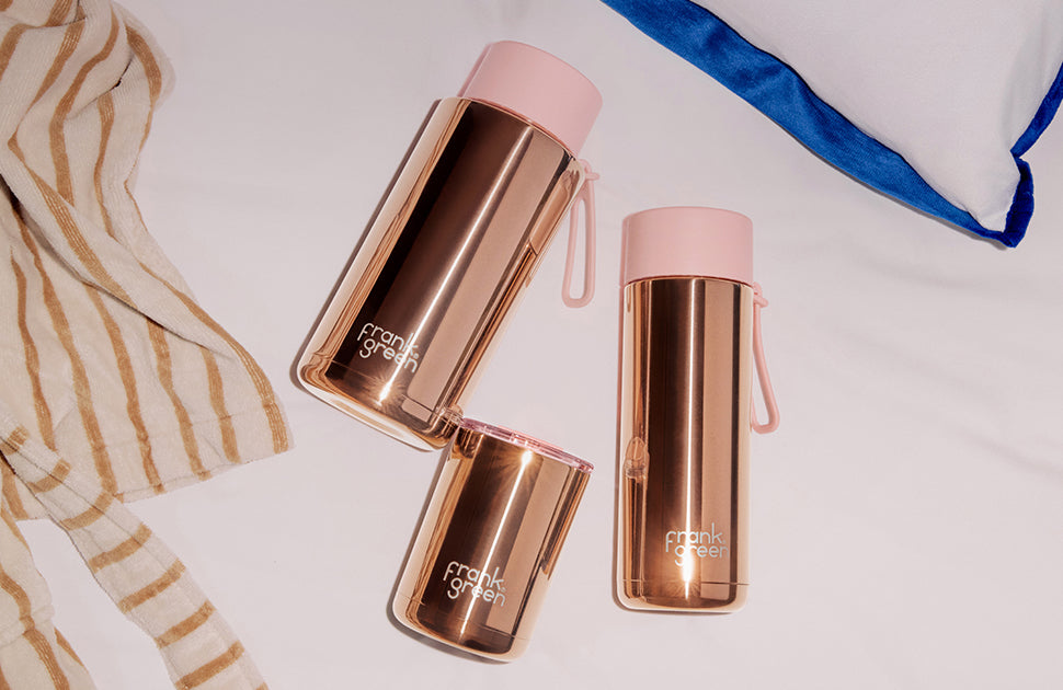 Frank Green rose gold chrome ceramic reusable bottle with flip straw lid, 34oz, featuring sleek design and durable construction.