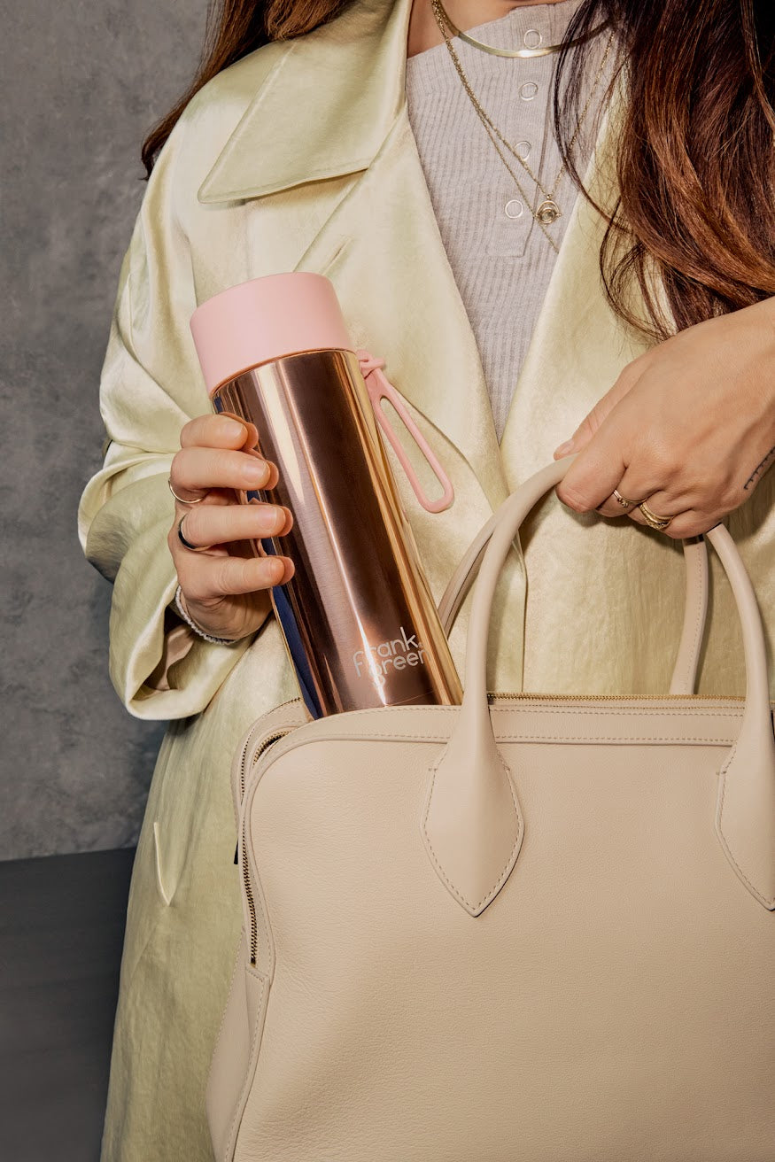 Frank Green 20oz rose gold chrome ceramic reusable water bottle with flip straw lid, stylish and eco-friendly hydration option.