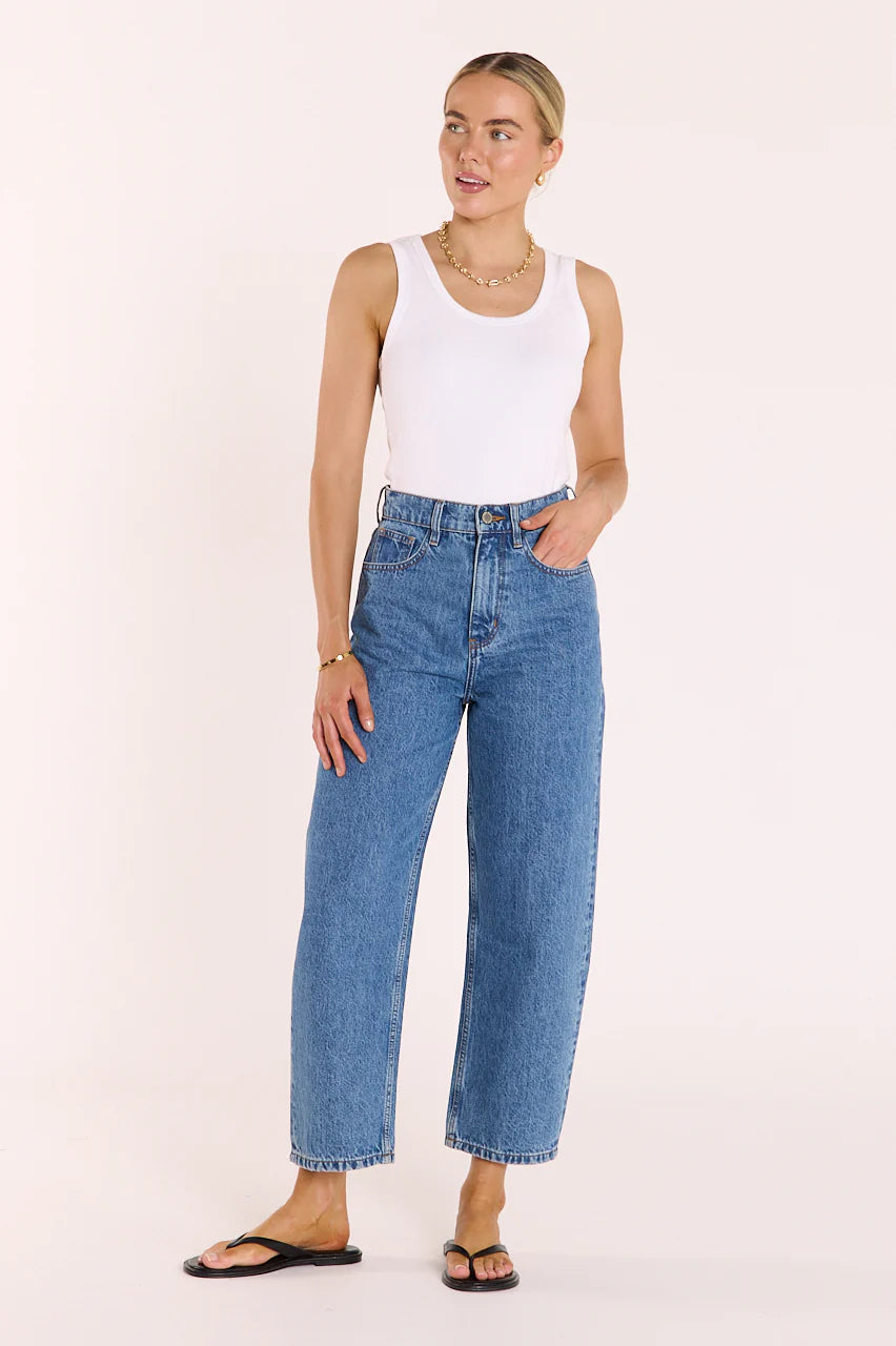 Feather + Noise Lola Cropped Barrel Jeans in deep blue, showing the high-waisted, relaxed fit with rolled cuffs and classic denim texture.