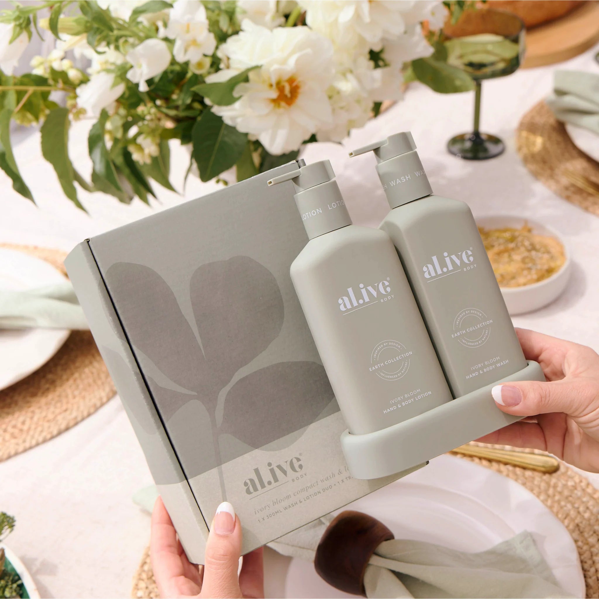 Al.ive Body Compact Bathroom Duo with ivory wash and lotion bottles, eco-friendly packaging, and minimalist design.