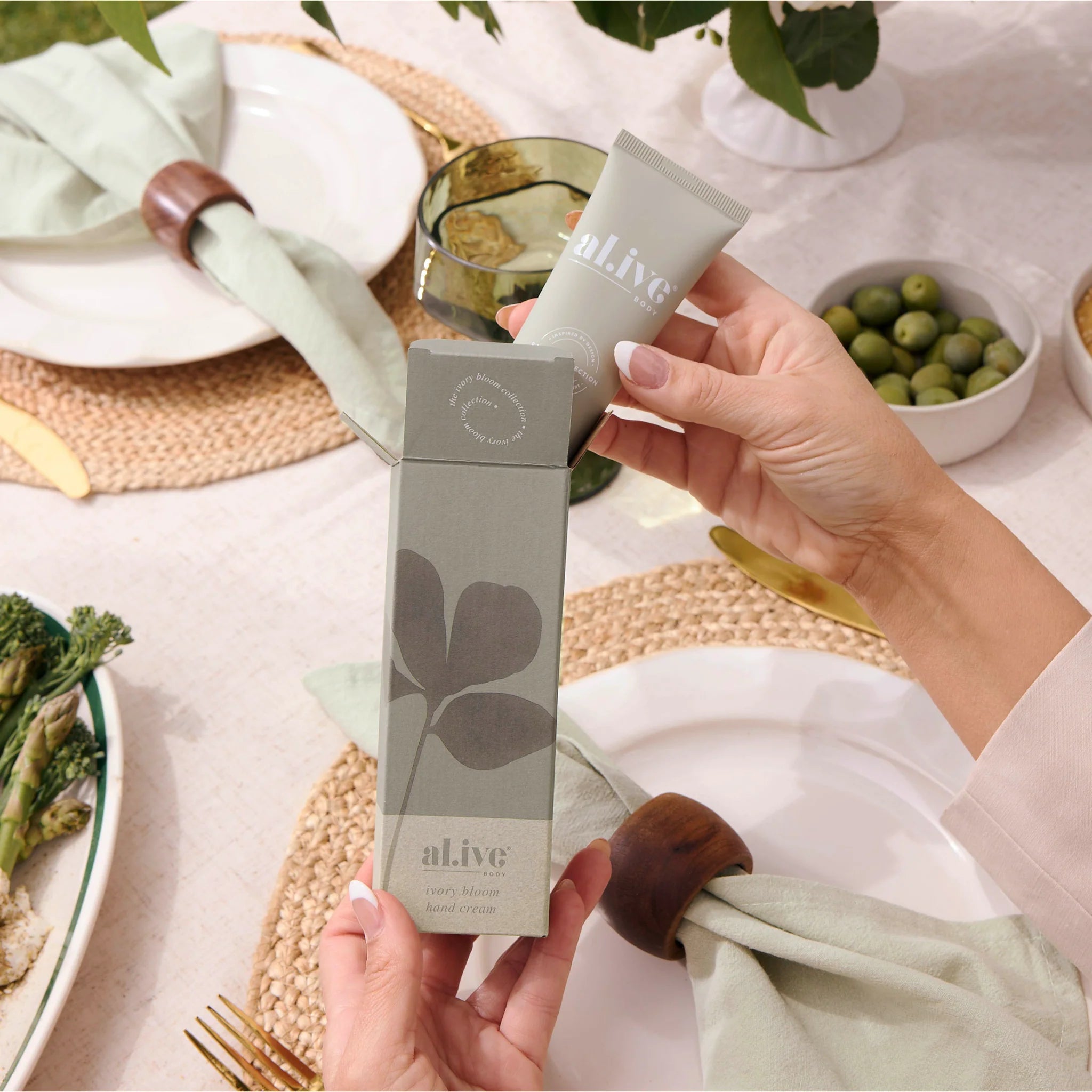 Al.ive Body Ivory Bloom hand cream tube with floral design, showcasing a luxurious moisturizing hand care product.