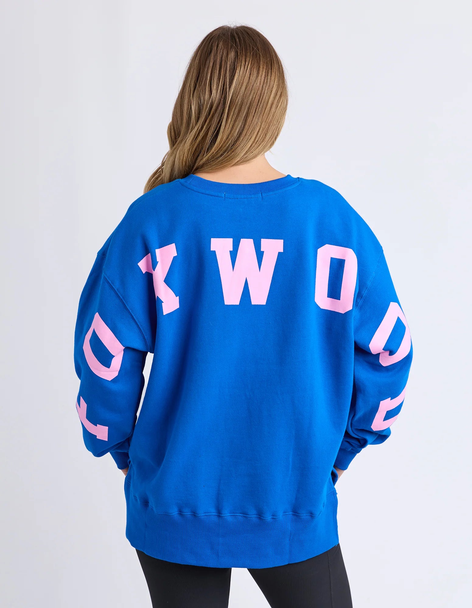 Foxwood Interval Crew in cobalt and neon pink, showing a close-up of the colorful, comfortable knit fabric and vibrant design.