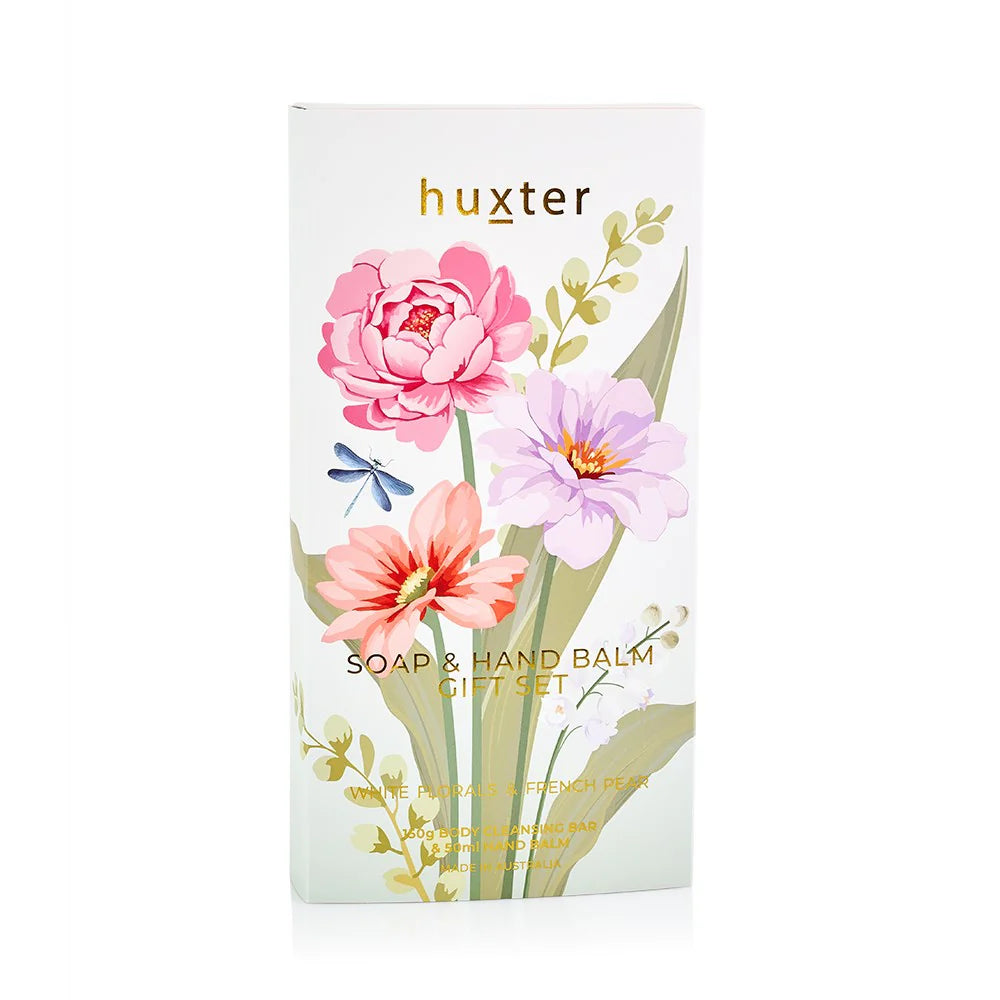 Huxter soap and hand balm gift set featuring white floral and French pear scents, with elegantly packaged bottles and lids.