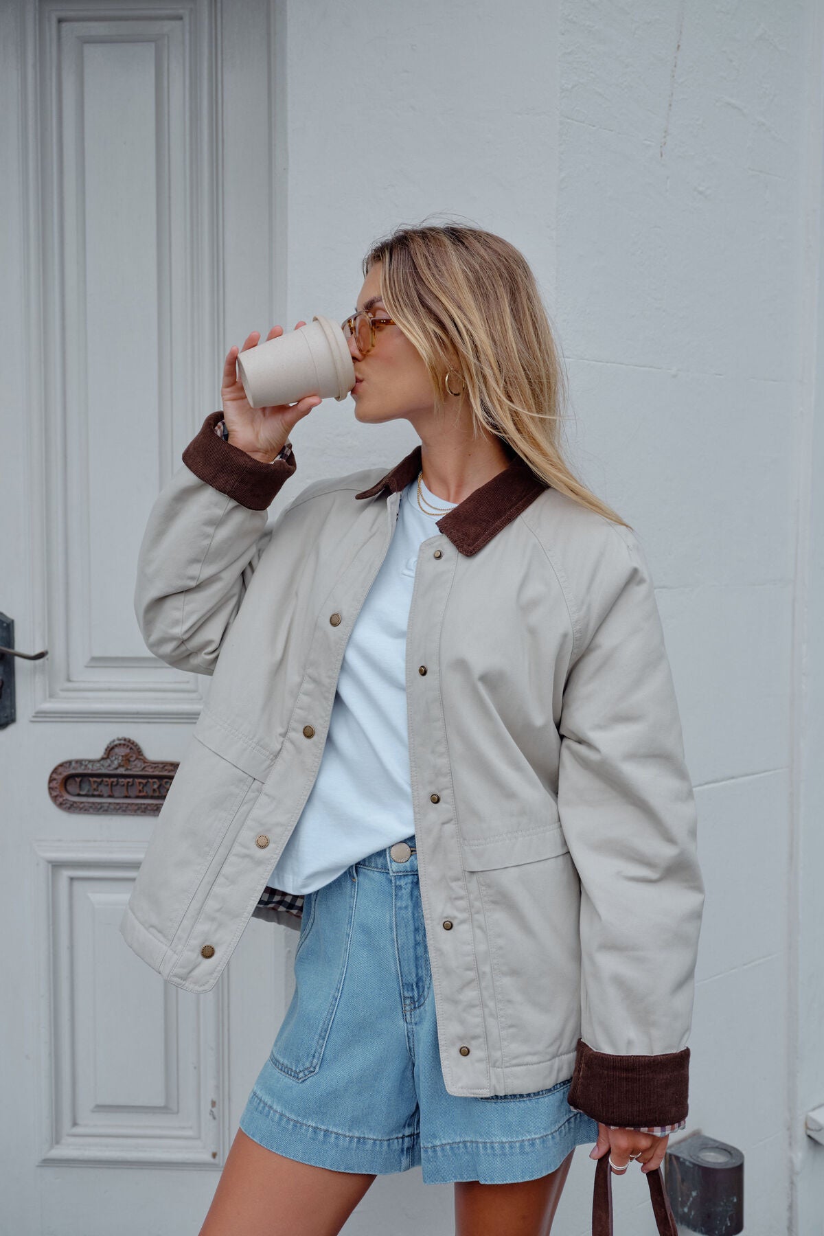 Ceres Life Blair Barn Jacket hanging on a wooden hanger, showcasing its rustic barn-inspired design and cozy outdoor style.