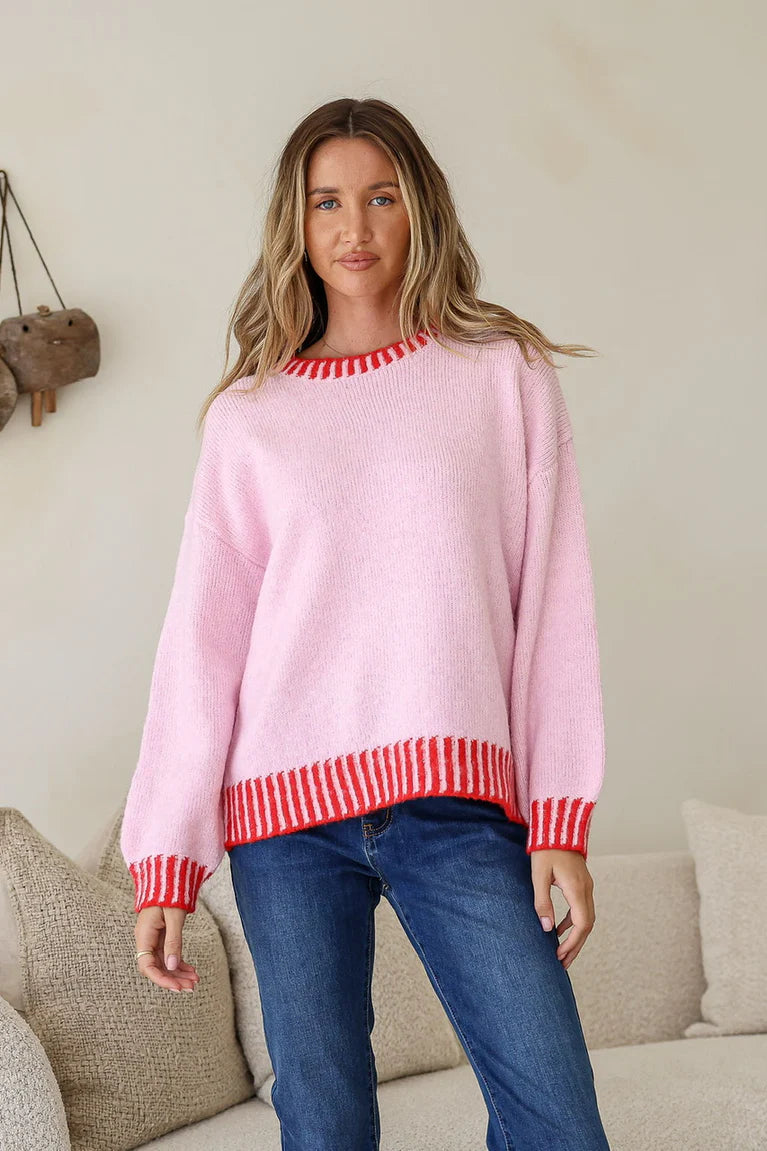 Miss Marlow pink and red knit sweater, close-up view showing soft fabric and vibrant color details.