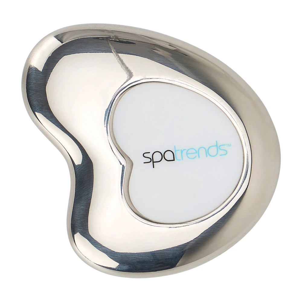 Stainless steel cool Gua Sha tool by Annabel Trends, smooth-edged facial massage device on a white background
