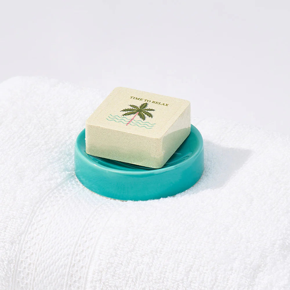 Mint-colored shower steamer dish by Annabel Trends, shaped for easy use and storage in the bathroom.