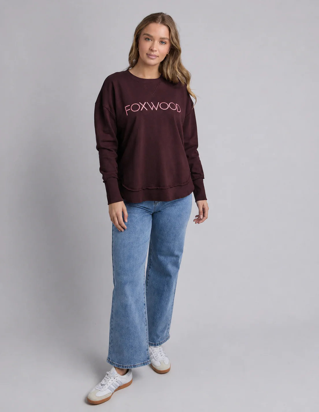 Foxwood Simplified Metallic Port Burgundy crew neck sweater displayed on a hanger, showcasing its rich color and smooth fabric.