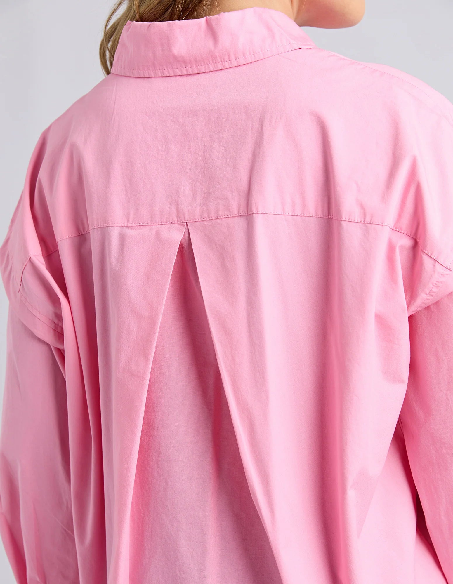 Foxwood Georgina Rose shirt displayed on a hanger, featuring soft pink fabric and classic button-up design for casual or dressy wear.