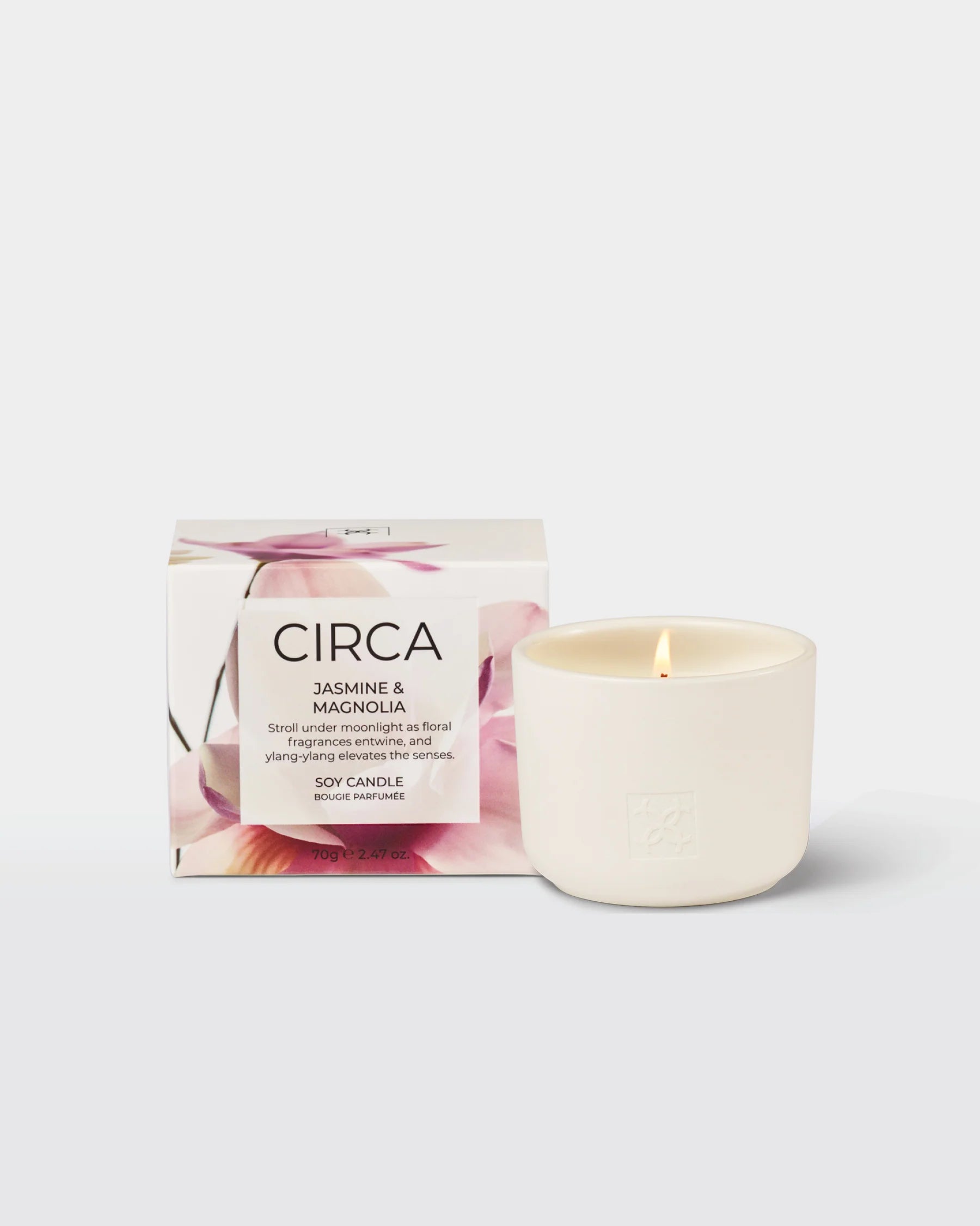 CIrca Jasmine & Magnolia soy candle in 300g glass jar with floral design, showcasing the candle with a lit wick and elegant packaging.
