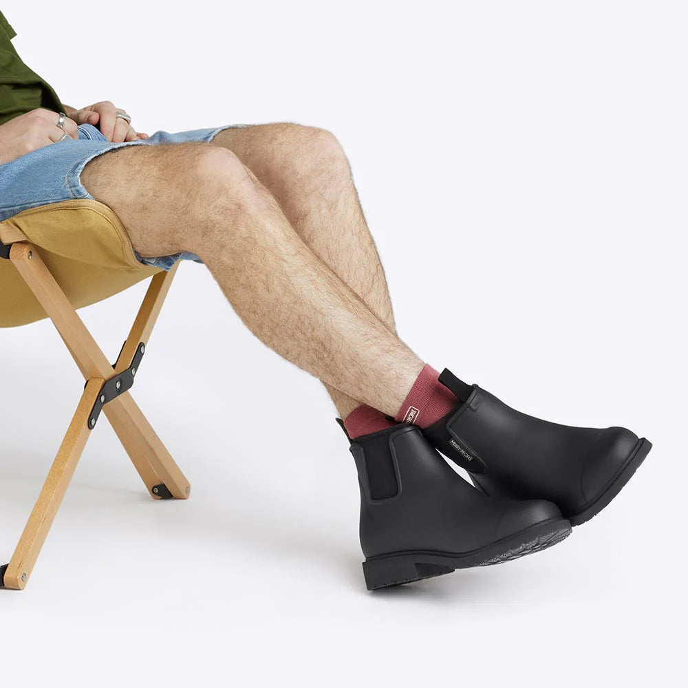 Black Bobbi ankle boot by Merry People, showcasing sleek black leather with a rounded toe and low block heel.