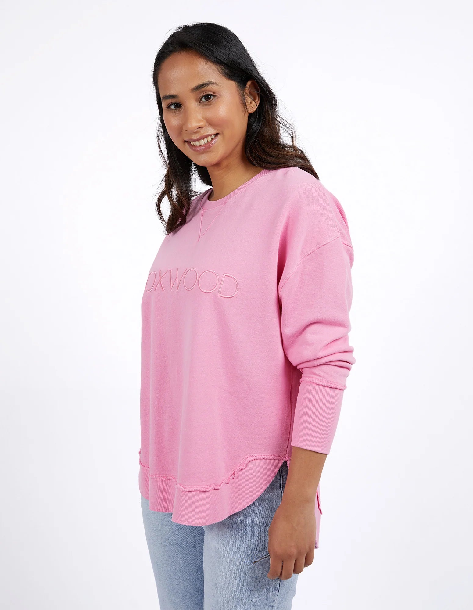 Foxwood Simplified Crew Bubblegum Pink sweatshirt displayed on a hanger, showcasing its soft fabric and casual fit.