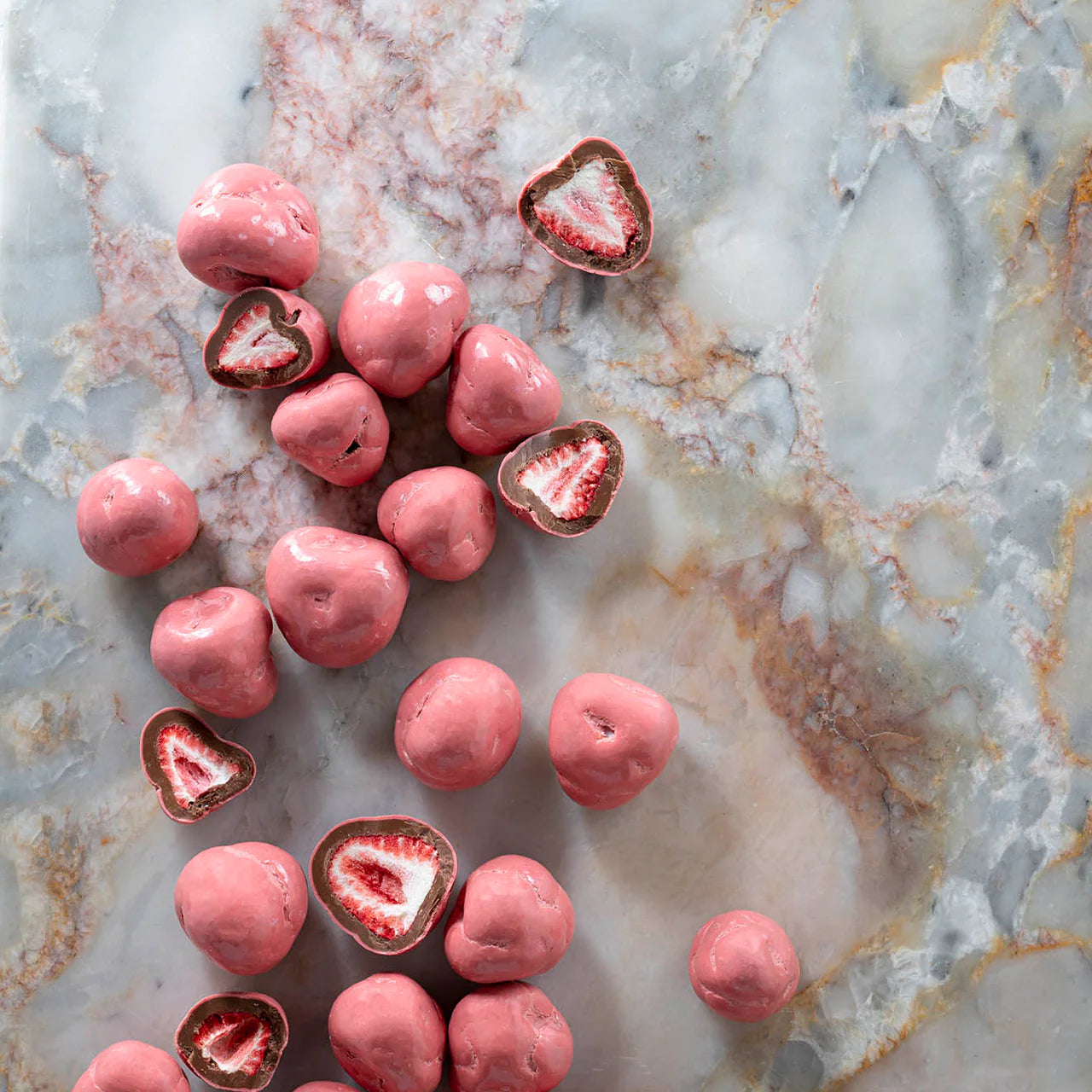 Milk chocolate coated whole strawberries in a 150g package by New Farm, fresh and glossy with chocolate coating visible.