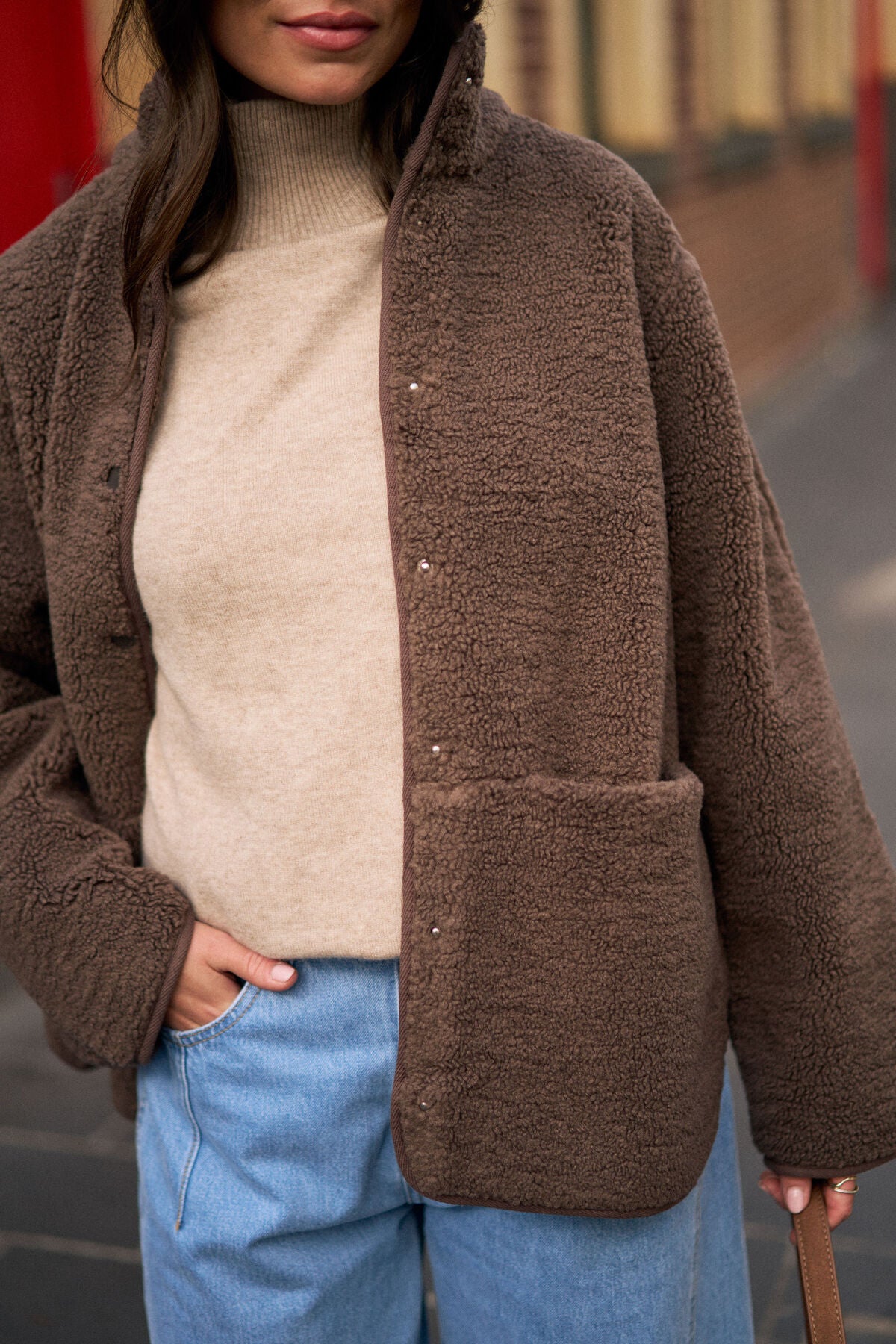 Chocolate teddy jacket by Ceres Life, soft plush exterior with a cozy fit, shown on a model in a casual outdoor setting.